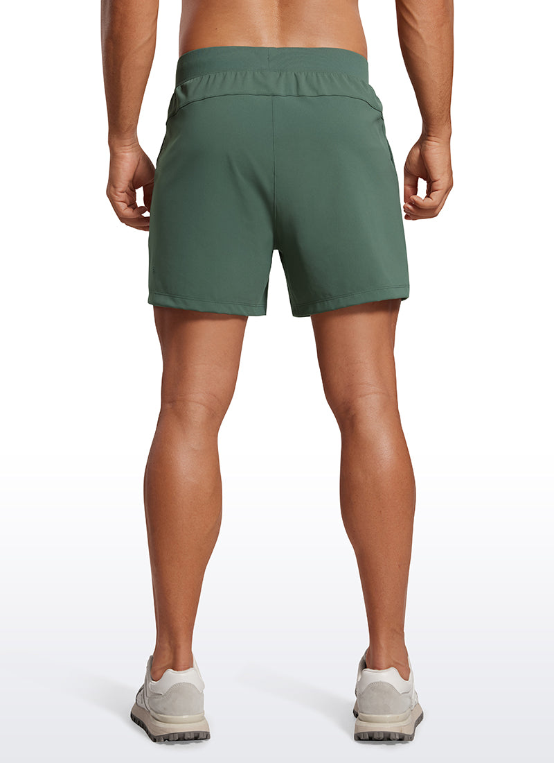 CRZ YOGA Men's Train Relaxed Fit On the Travel Linerless Shorts 5'' Dark Forest Green