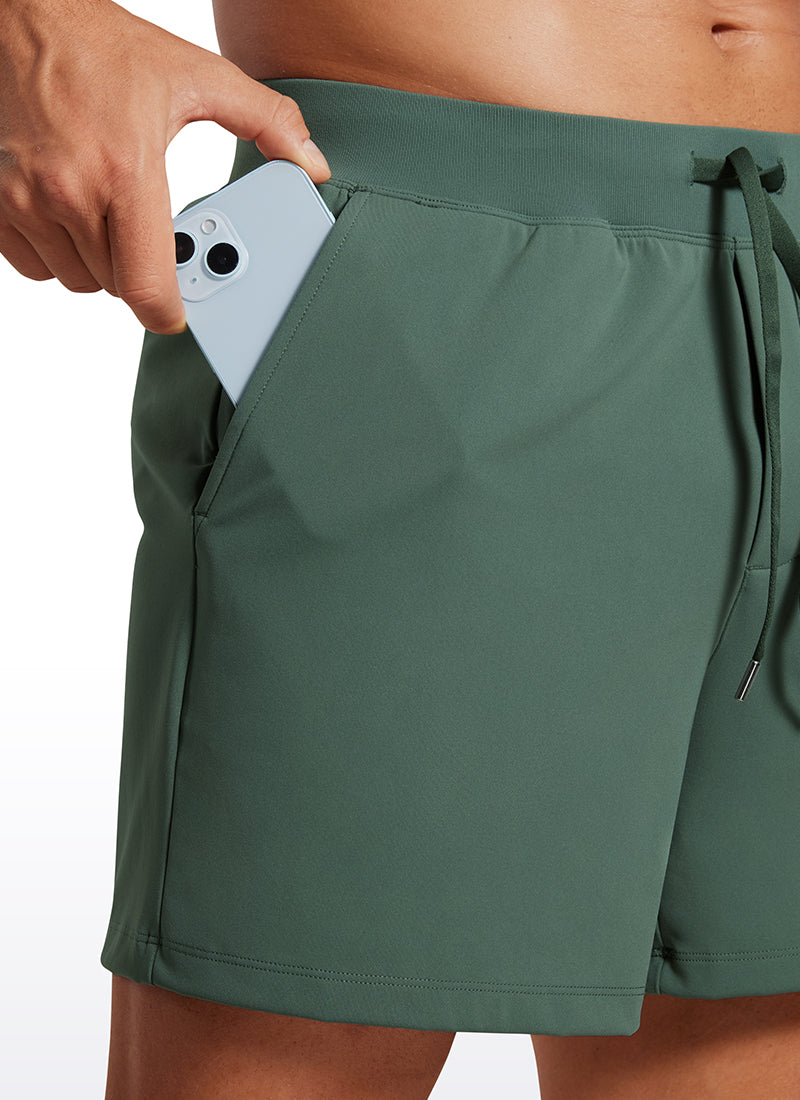 CRZ YOGA Men's Train Relaxed Fit On the Travel Linerless Shorts 5'' Dark Forest Green