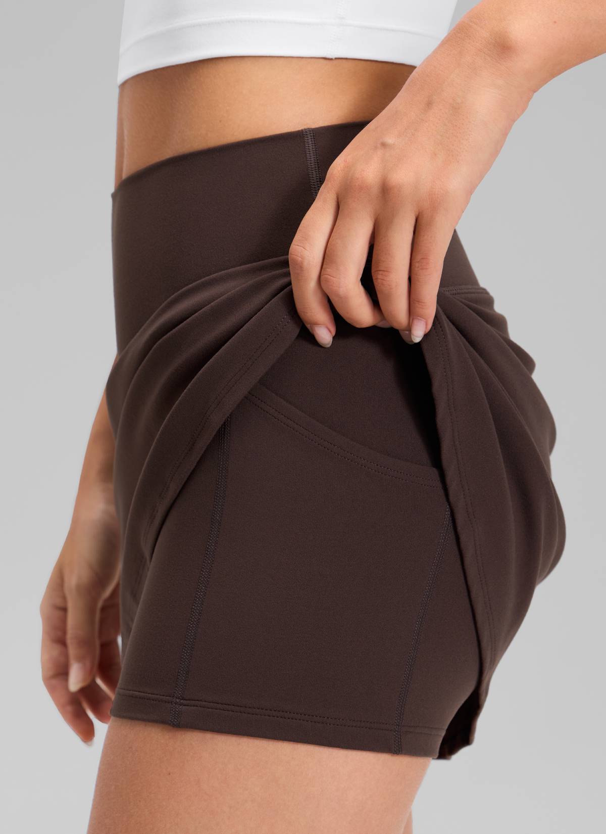 CRZ YOGA Women's Butterluxe High Rise Tennis Skirts 14.5'' with Pocket Hot Fudge Brown @model_info:Anna