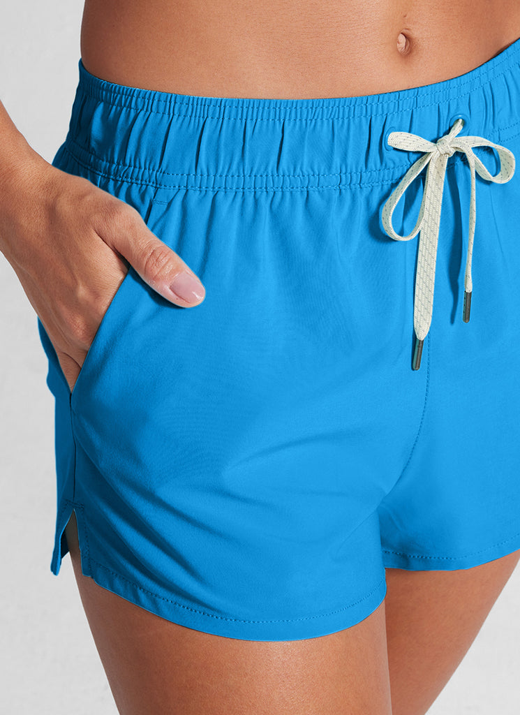 CRZ YOGA Women Mid Waisted Swim Shorts Side Splits Liner Pockets 3" Madagascar Blue